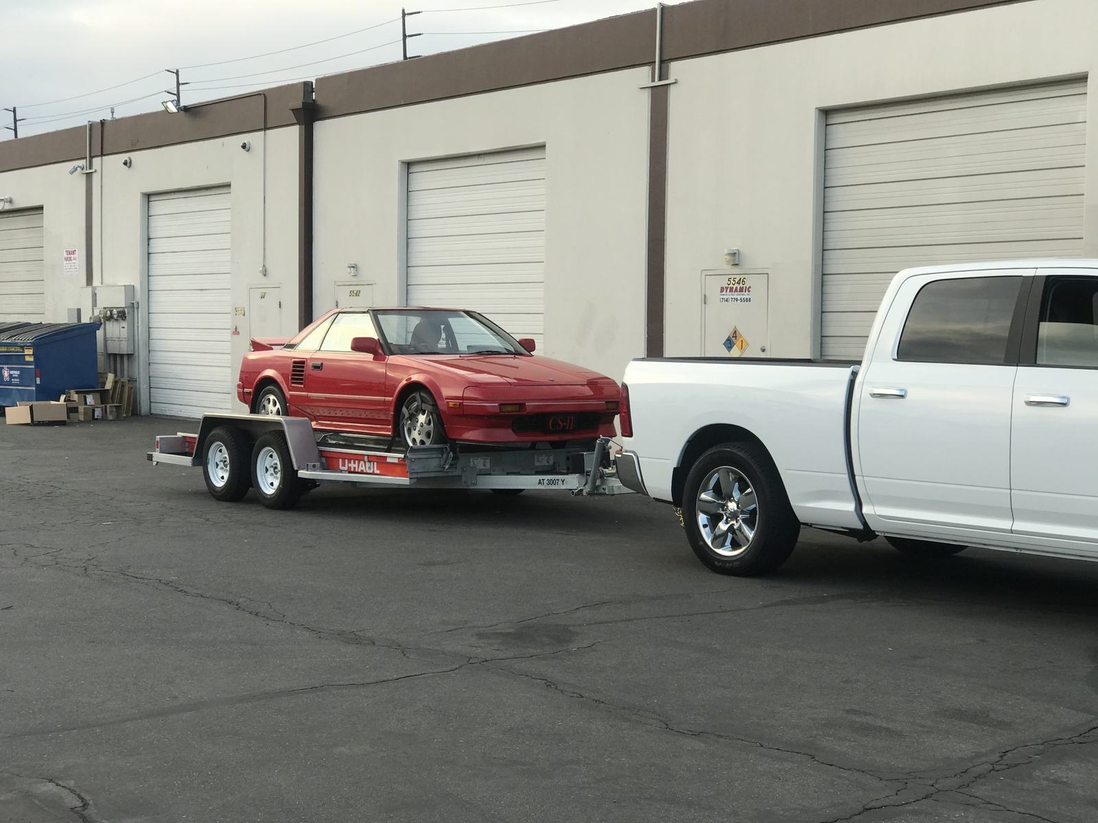 Staging area — the MR2 alongside a Ferrari 488 waiting to enter the hall