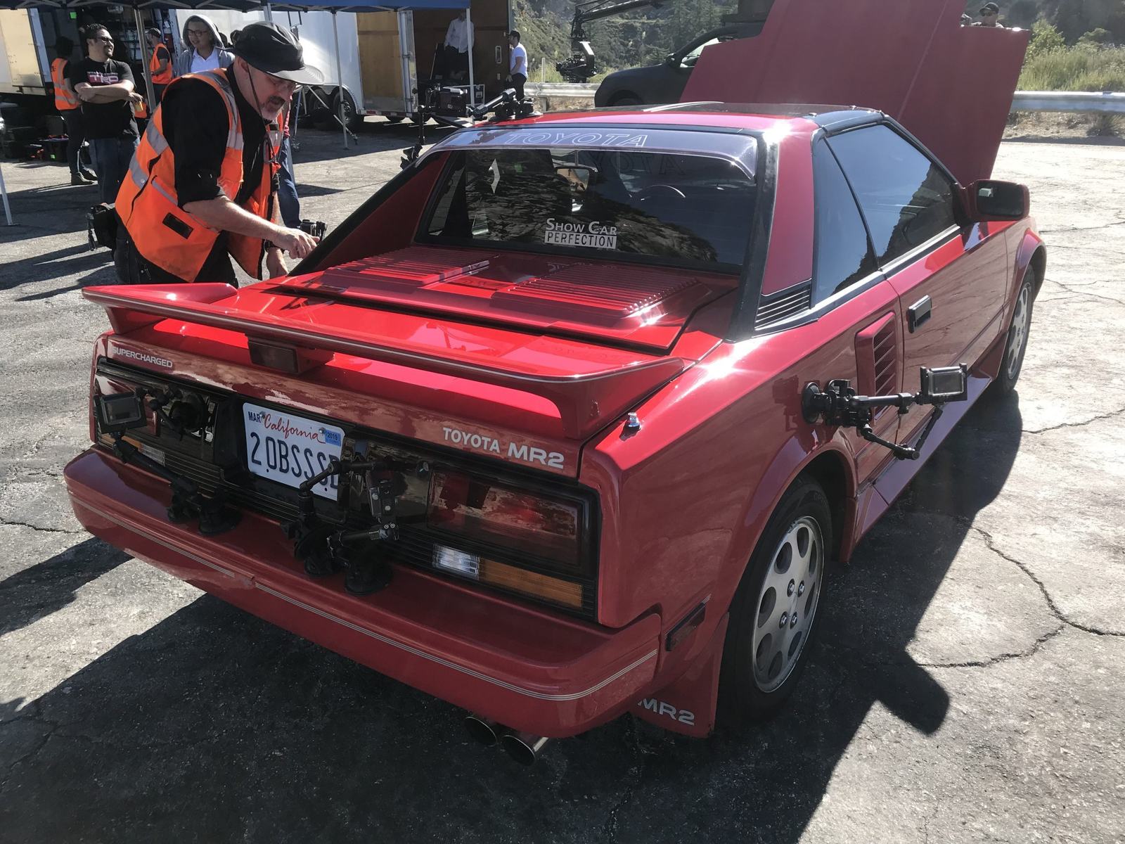 The MR2 on the lift — Jay's team examining the undercarriage