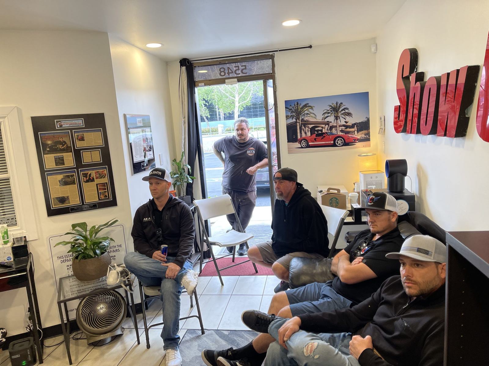 ShowCarPerfection lobby at 5548 E La Palma Ave, Anaheim CA — the 3D ShowCar sign, press clippings wall, and waiting area